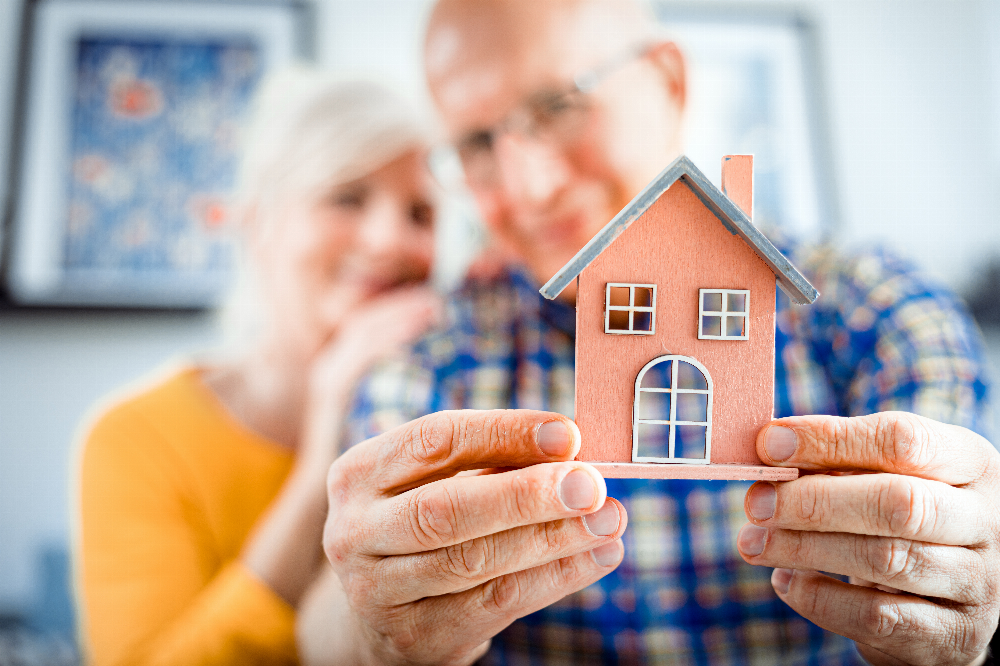 An Image of Seniors Holding A Home